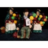 Three Royal Doulton bone china figurines; 'The Old Balloon Seller' HN1315 x 2 and 'The Balloon