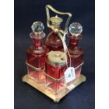 Early 20th Century silver plated and cranberry four piece cruet set on stand. (B.P. 21% + VAT)