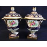 Pair of continental decorative porcelain urn shaped two handled lidded vases with pierced