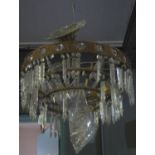 Large brass eight-branch chandelier over all with prismatic cut glass swags and droppers. (B.P.