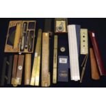 Box of assorted slide rules, general rulers, spirit level, artisans wooden folding ruler with