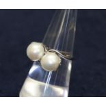 Double cultured pearl ring in crossover style set in white metal. (B.P. 21% + VAT)