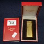 Cartier gold plated ribbed design classic cigarette lighter, in original box with worldwide