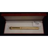 A Cartier of Paris gold plated ball point pen with bark finish in red leather original Cartier