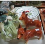 A pair of ceramic Corgi dogs, together with two Royal Doulton bone china figurines 'Buttercup'