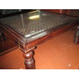 A modern stained hardwood coffee table with glass inset and metal decoration. (B.P. 21% + VAT)