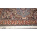 Persian design carpet on a blue ground with floral and foliate decoration. Modern. 294 x 187 cm