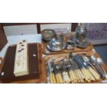 Three trays of metalware to include; plated flatware, toast racks, teapot on associate stand,