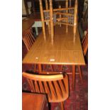 Ercol design teak table with drop ends, together with a set of four Ercol style spindle kitchen