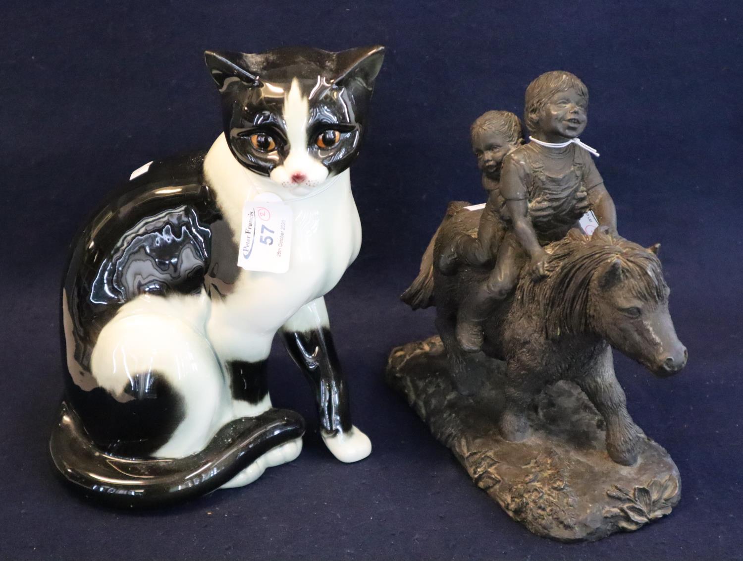 A Goebels German china study of a seated cat, 27cm approx. Together with a bronzed resin Thelwell