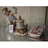 Meissen porcelain figurine of a semi-nude putti holding birds on a naturalistic base. Blue cross