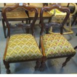 Pair of Victorian mahogany dining chairs with geometric upholstered drop in seats on turned
