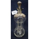 Silver mounted waisted and wrythen glass decanter with repousse stopper, plain collar and pierced