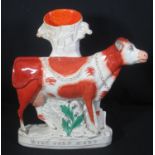 19TH CENTURY STAFFORDSHIRE POTTERY ADVERTISING SPILL VASE as a chained cow by tree stump with