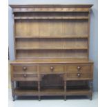 19TH CENTURY WELSH OAK TWO STAGE POT BOARD DRESSER having moulded cornice above boarded back with