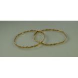 A PAIR OF 18CT GOLD BANGLES wrapped with plated wire. Weight 16.2g approx. (B.P. 21% + VAT)
