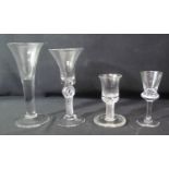 FOUR 19TH CENTURY DRINKING GLASSES to include; a firing glass with multiple air twist stem, a tall