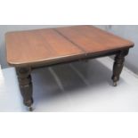 VICTORIAN WALNUT EXTENDING DINING TABLE with three additional leaves, the moulded top with flower