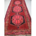 IRANIAN RUNNER on a pink and red ground, full pile with central medallion, stylised foliate and