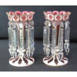 PAIR OF 19TH CENTURY BOHEMIAN OVERLAY GLASS VASE LUSTRES with petaled mouths, tapering stems and