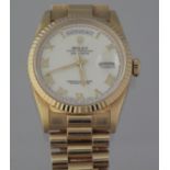 ROLEX OYSTER PERPETUAL DAY DATE WATCH having round 18ct yellow gold case with fluted bezel, cream