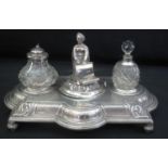 VICTORIAN SILVER INK STAND in classical design with central cast figure covering well, flanked by
