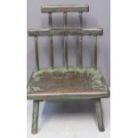 UNUSUAL PRIMITIVE CHILD'S CHAIR having moulded slab seat standing on chamfered legs with remnants of
