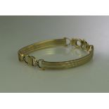 9CT WHITE AND YELLOW GOLD BRACELET of two curved bars with horseshoe links. Weight 13.2g approx. (