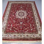 KASHMIRI RED GROUND FLORAL SHARBASS MEDALLION DESIGN RUG. 230 x 159cm approx. 20th Century. (B.P.