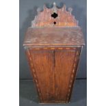 18TH/EARLY 19TH CENTURY PROBABLY WELSH OAK CANDLE BOX with fretted pediment above hinged door, the