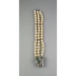 THREE STRAND CULTURED PEARL BRACELET with large diamond and emerald clasp. Length 8" (20cm)