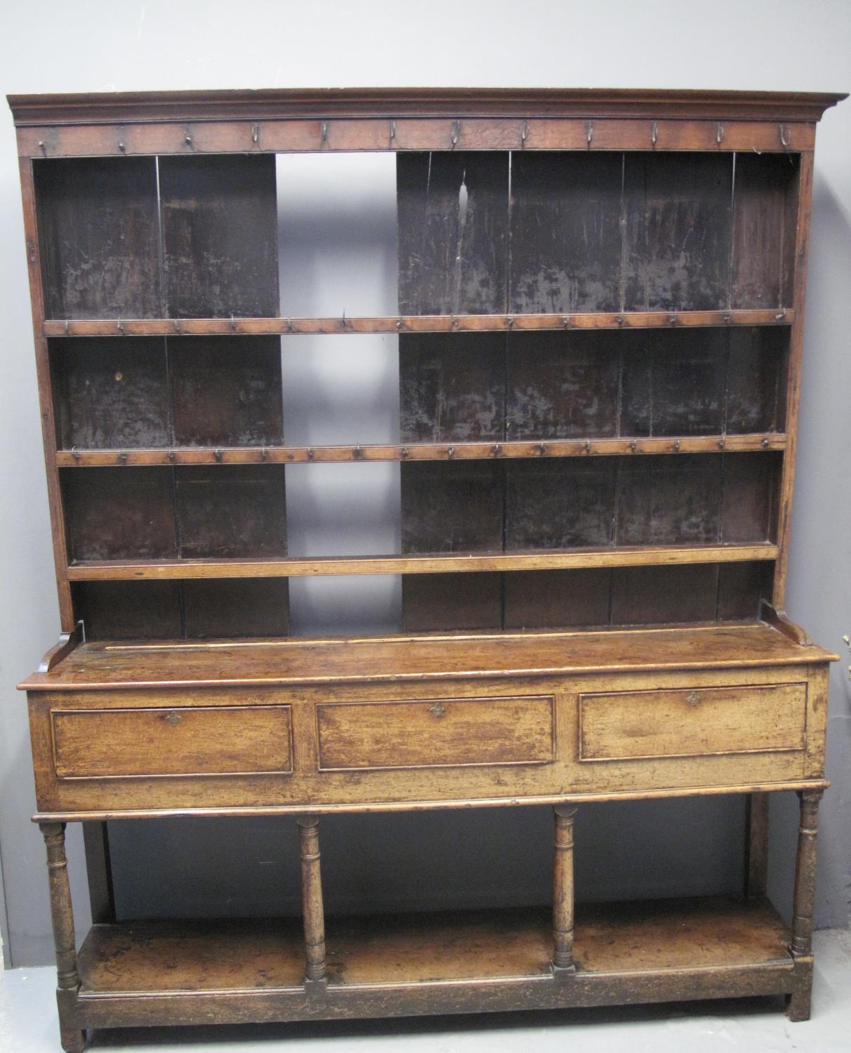 EARLY 19TH CENTURY WELSH OAK POT BOARD DRESSER having moulded cornice above iron hooks and