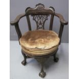 LATE VICTORIAN WALNUT SWIVEL OPEN ARMCHAIR, the carved back with pierced ribbon and tassel