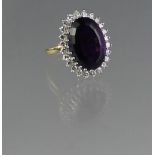 18CT GOLD AMETHYST AND DIAMOND RING. The oval amethyst approx 16 x 11mm. Ring size J. Weight 6.9g
