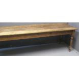 19TH CENTURY PINE FARMHOUSE KITCHEN TABLE of rectangular form with three plank top, above ring