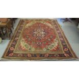 MIDDLE EASTERN HAND KNOTTED FOLIATE DESIGN RED GROUND CARPET with dark blue borders and cream ground