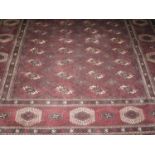 LARGE IRANIAN BELUSHI BOKHARA DESIGN DARK RED GROUND TRIBAL RUG with typical guls to the field