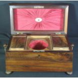 AN EARLY 19TH CENTURY ROSEWOOD TEA CADDY, of sarcophagus form having hinged lid, the interior