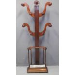 A VICTORIAN MAHOGANY TREE SHAPED UMBRELLA AND HAT STAND of scrolled form with open umbrella stand on