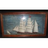 19TH CENTURY NAIVE CASED HALF BLOCK MODEL of a square rigger under full sail with small gaff