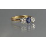 18CT GOLD THREE STONE DIAMOND AND SAPPHIRE RING. Ring size K & 1/2. Weight 2.9g approx. (B.P.