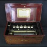 19TH CENTURY SWISS MUSICAL BOX having foliate inlaid and cross banded case with ebonised edging.