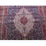 LARGE BLUE GROUND KASHMIRI CARPET overall with traditional all over floral design with central ivory