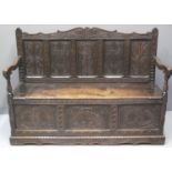 17TH CENTURY STYLE STAINED OAK SETTLE having carved scroll foliate back above five carved and