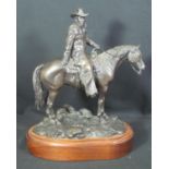 DON TONEY (Contemporary bronze sculptor born 1954), cowboy on horseback on a naturalistic rocky