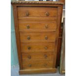 VICTORIAN PALE OAK WELLINGTON CHEST having moulded top with carved decoration above a straight front