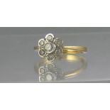 18CT GOLD DIAMOND SEVEN STONE DAISY CLUSTER RING. Ring Size O. Weight 4.1g approx. (B.P. 21% +