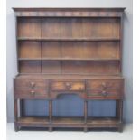 19TH CENTURY WELSH OAK POT BOARD DRESSER having moulded cornice above boarded shelf and three fitted