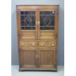 EARLY 19TH CENTURY WELSH OAK BOOKCASE CUPBOARD having two glazed doors, the interior revealing two
