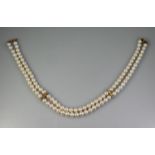 DOUBLE ROW OF MIKIMOTO CULTURED PEARLS with 18ct gold diamond set supports and clasp. Length 142 (